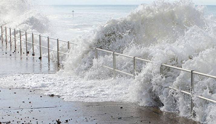 Wave crashing on boardwalk