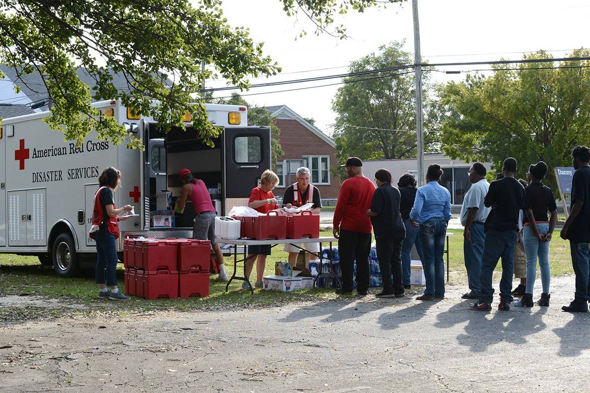 Steve Havens and Jan Unger of Michigan, and Tom Jacobs and Anne Johnson of Flagstaff, Arizona, were tired after a long week of supporting Hurricane Matthew, but very proud of the long trip that they had made out to North Carolina, driving Red Cross Emergency Response vehicles.  They were very happy to finally have access to the Lumberton community, which had been rendered inaccessible by flood waters, and be able to bring hot food and warm smiles to the members of this community who suffered so much this week. Photo by Daniel Cima for the American Red Cross
