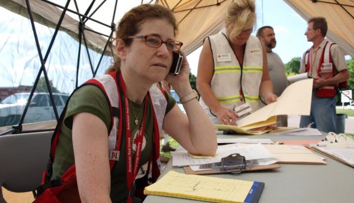 female red crosser speaking on phone