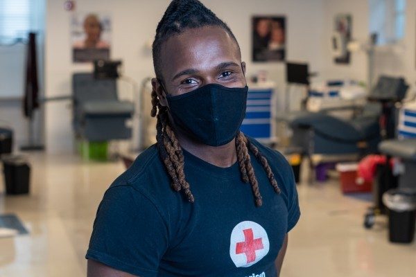 Portrait of a Red Cross volunteer wearing a mask to protect against coronavirus transmission.