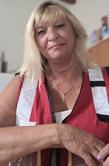 Janette Dearing, a Red Cross Volunteer, posing in her Red Cross vest. 