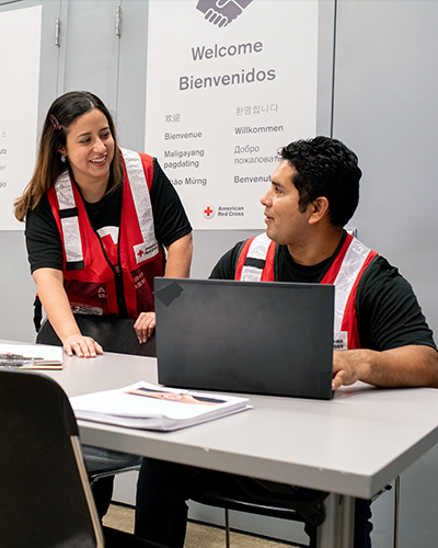 woman holding bucket with red cross logo