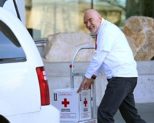 red cross volunteer welcoming donors in their role as a blood donor ambassador