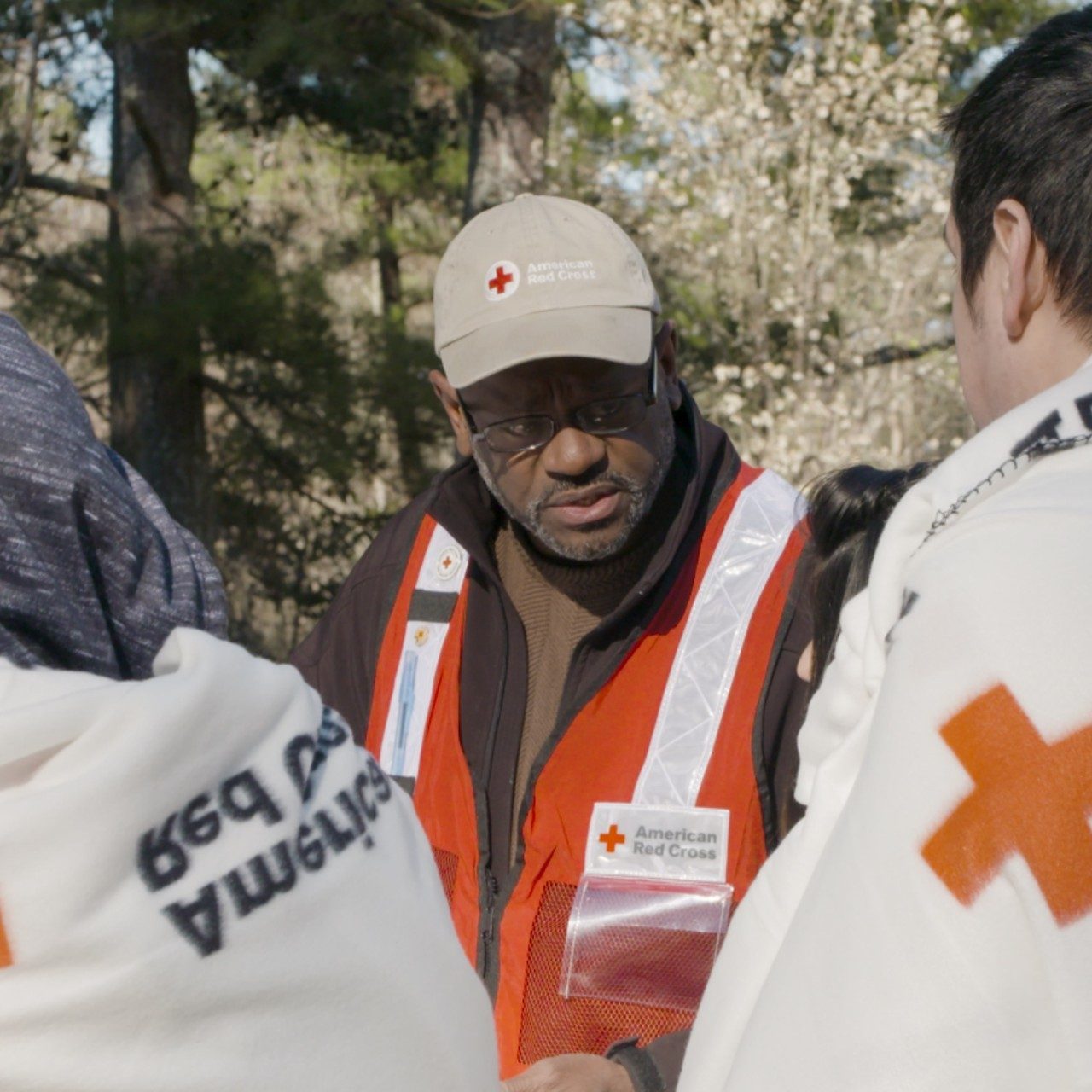 A Red Cross volunteer helping a family affected by a home fire.