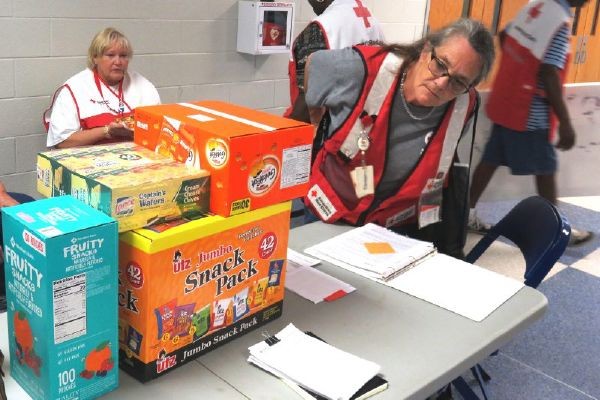Hurricane Florence volunteers checking supplies in shelters