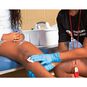 A person using the QuikClot Advanced Clotting Gauze on an injured person's knee.