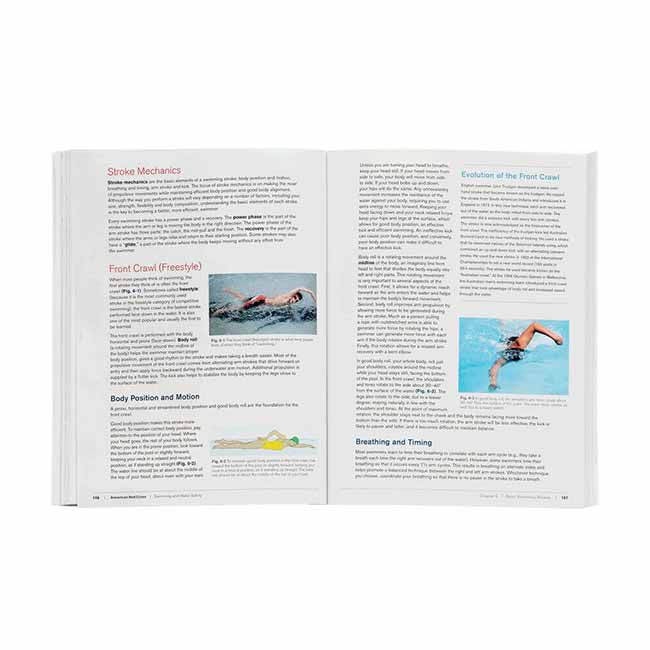 Red Cross Swimming and Water Safety Manual opened to pages showing stroke mechanics, body positioning and motion, and breathing and timing for the front crawl (freestyle) swimming stroke.