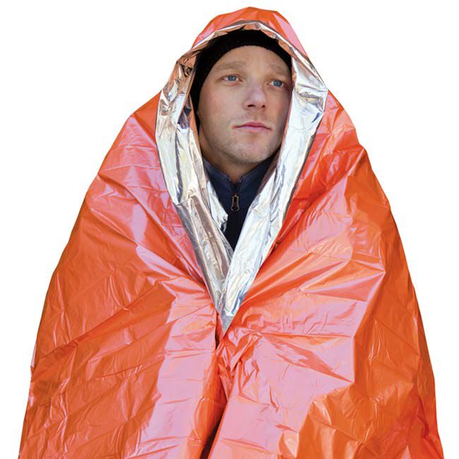 A person wearing the Survive Outdoors Longer (SOL) Emergency Blanket.