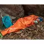 A person using the Survive Outdoors Longer (SOL) Emergency Bivvy.