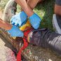 People applying a Sof Tactical Tourniquet to control bleeding on another person's leg.