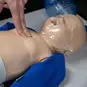 Student practicing CPR compressions on a Prestan Infant Manikin.