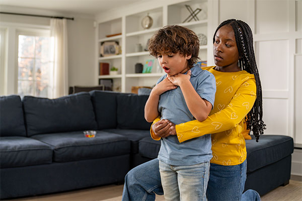 A babysitter helping a choking child by using techniques learned in the NYC Babysitter Training course.
